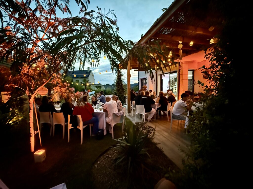 Réception de mariage installée en extérieur sous une pergola en bois