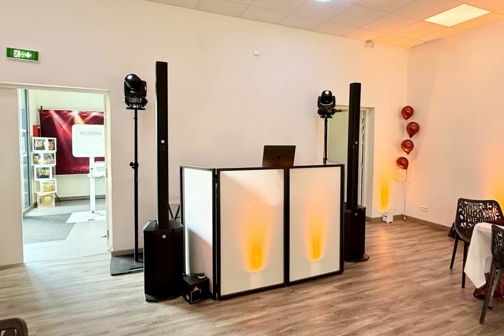Régie DJ installée dans une salle façon loft avec éclairage blanc